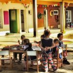 a group of children sitting around a table