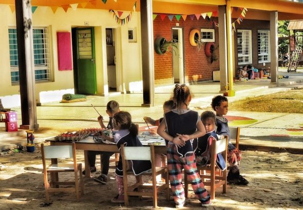 a group of children sitting around a table